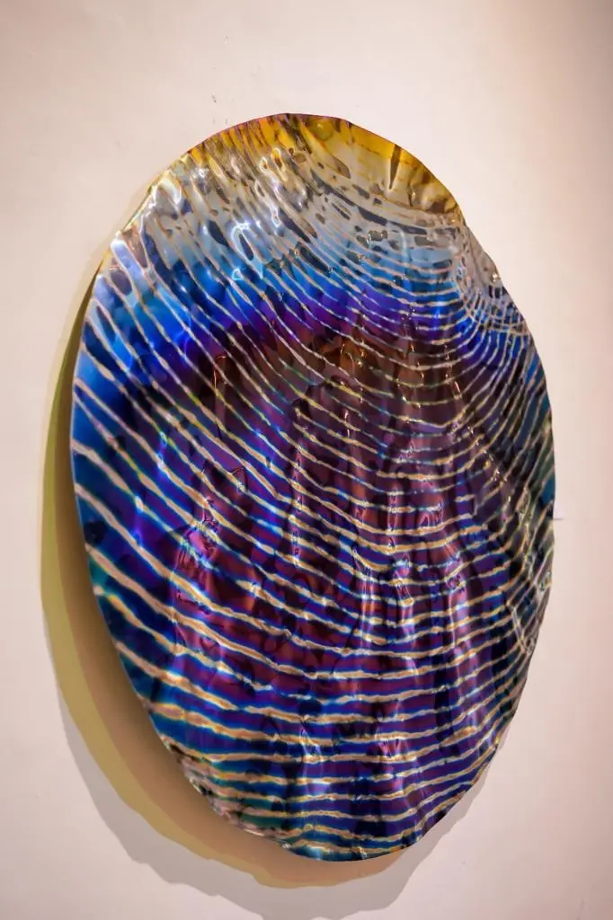 Concave azure and gold rippled mirror disc