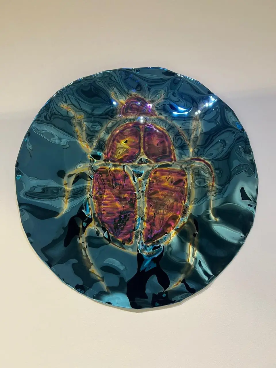 Blue mirror disc with an etched scarab motif